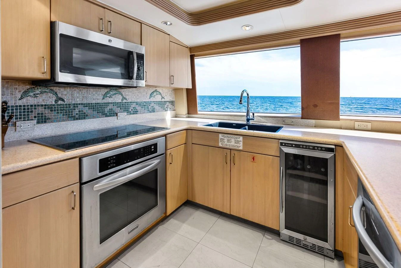 The galley features modern appliances and a stunning ocean view through large windows. aboard BRAVO ZULU Yacht for Sale