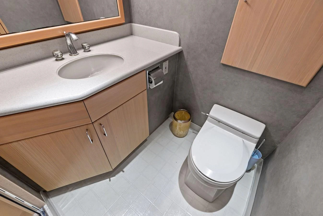 The yacht's head features a modern sink and toilet with sleek cabinetry and fixtures. aboard BRAVO ZULU Yacht for Sale