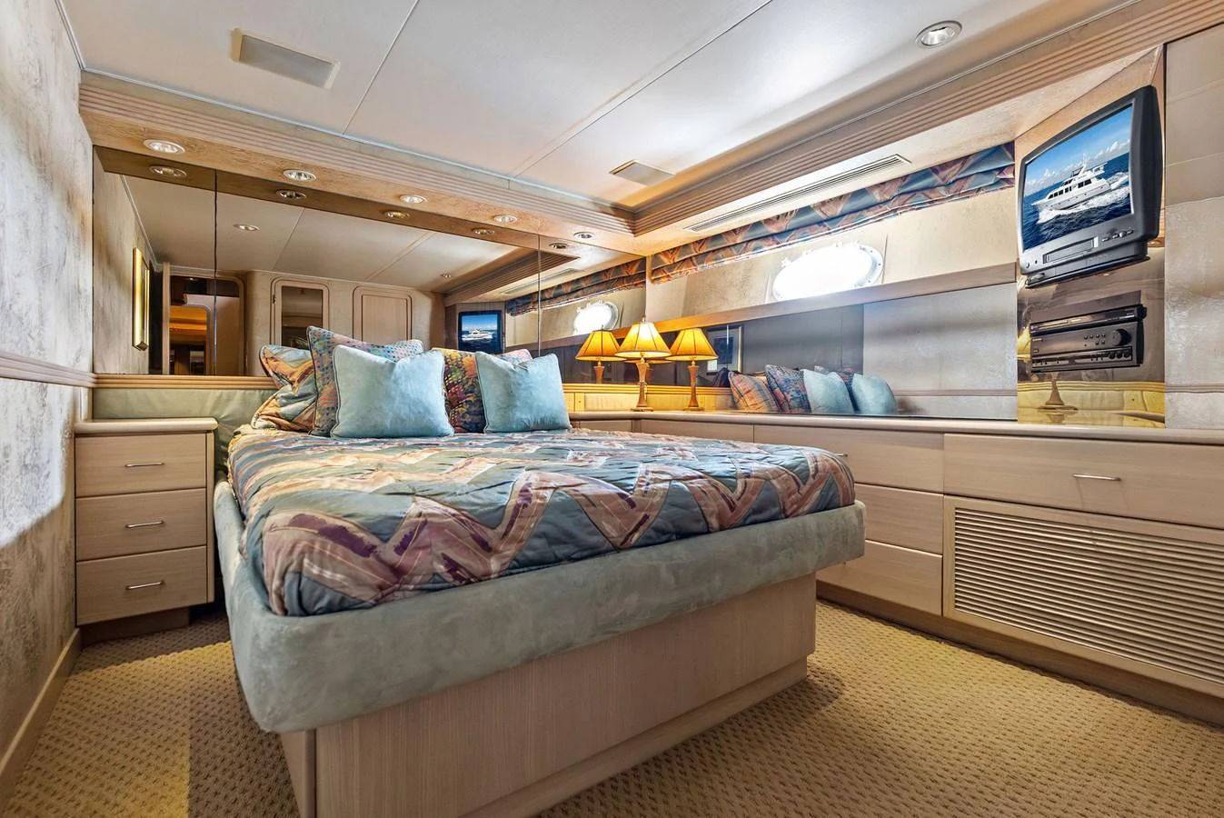 The stateroom features a plush bed with elegant bedding, ambient lighting, and ample storage space. aboard BRAVO ZULU Yacht for Sale