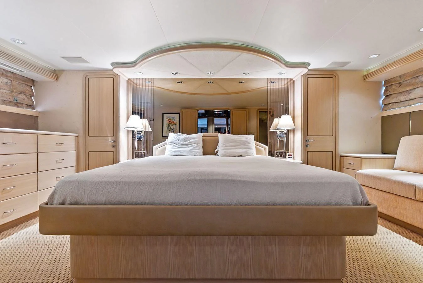 The master stateroom features a spacious bed with elegant wooden cabinetry and soft lighting. aboard BRAVO ZULU Yacht for Sale