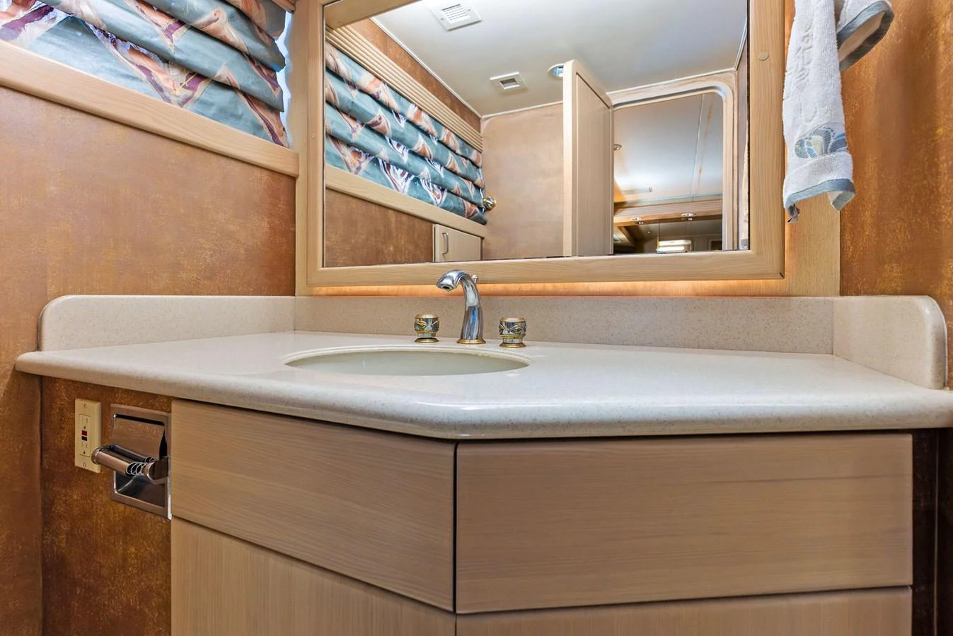 The yacht's bathroom features a sleek vanity with a modern sink and a large mirror. aboard BRAVO ZULU Yacht for Sale