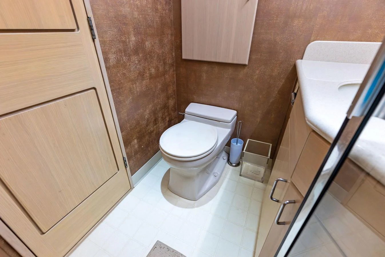 The yacht's head features a modern toilet and a sleek vanity with ample storage. aboard BRAVO ZULU Yacht for Sale