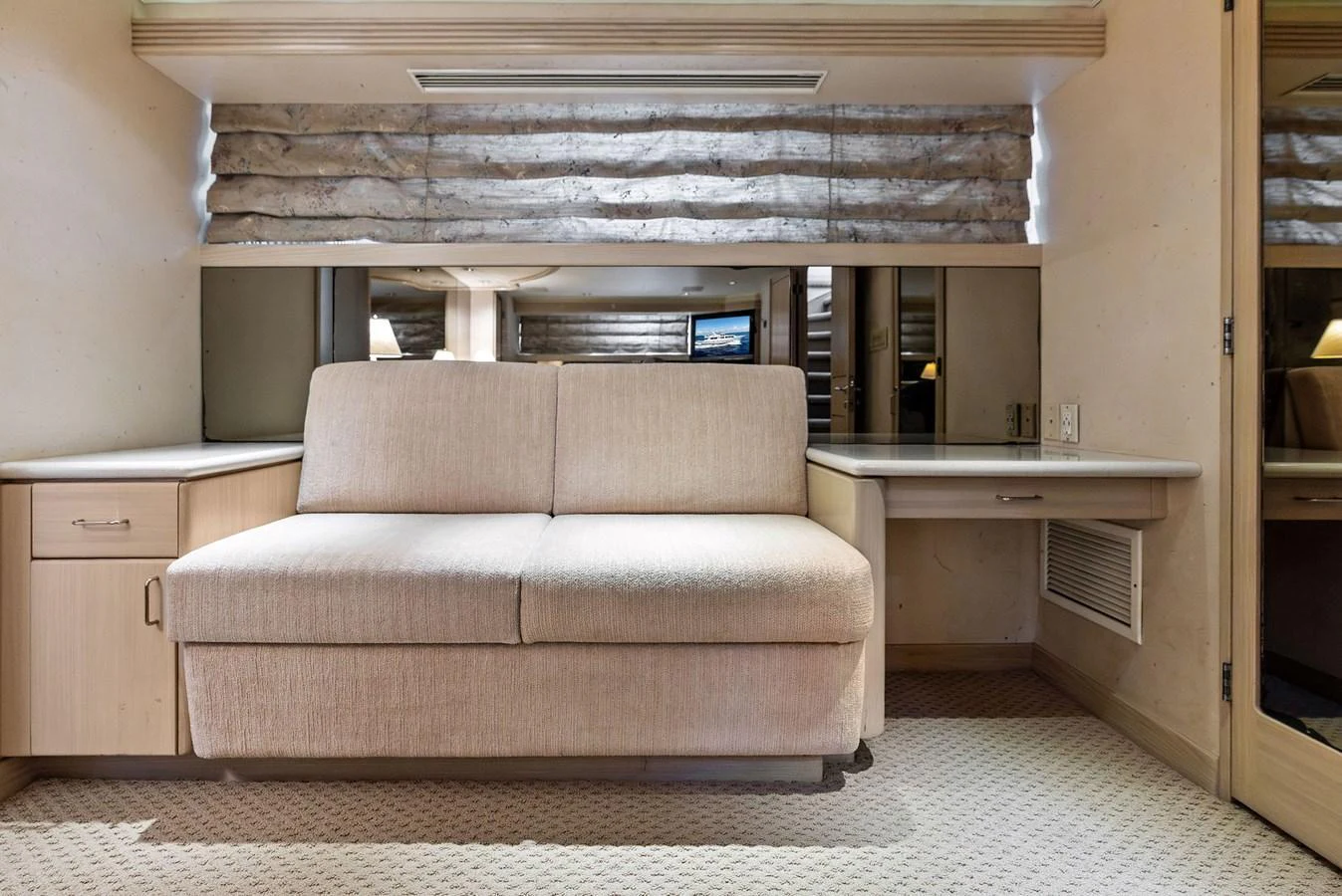 The stateroom features a comfortable sofa and built-in cabinetry, offering a cozy and functional space. aboard BRAVO ZULU Yacht for Sale