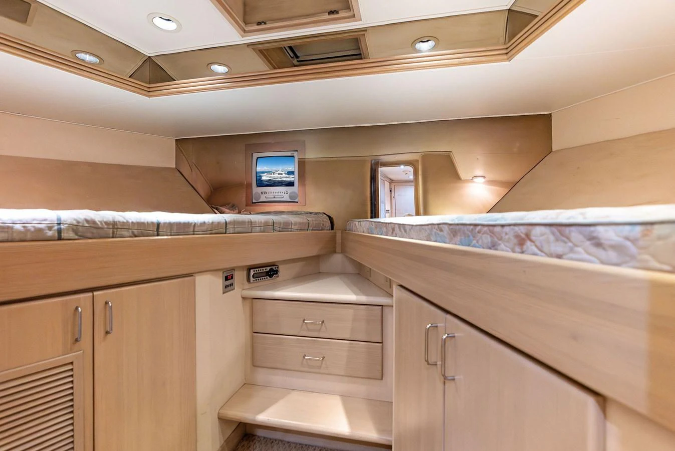 The cabin features twin beds with ample storage and a cozy atmosphere. aboard BRAVO ZULU Yacht for Sale