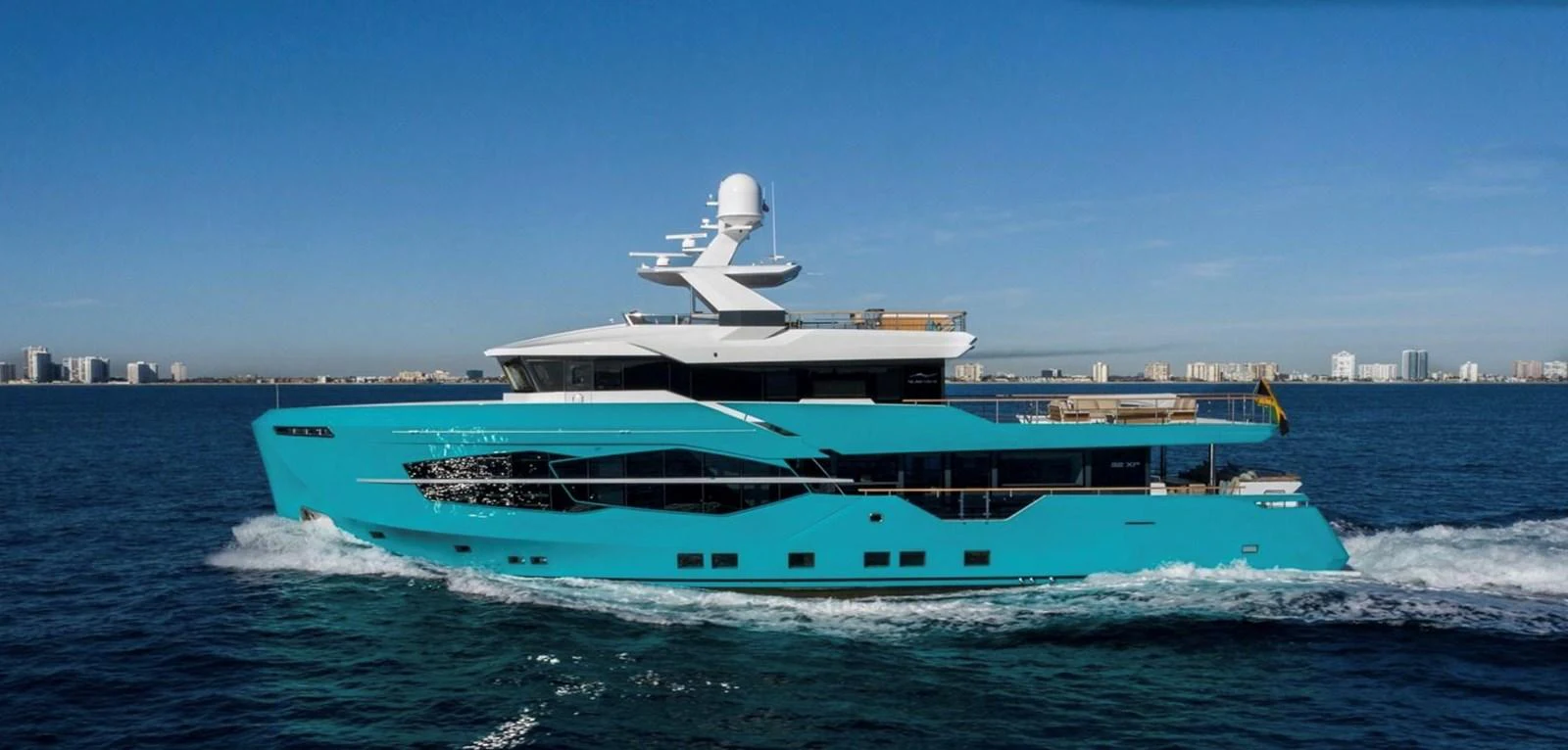 A sleek, modern yacht cruises on the open water under a clear blue sky. aboard M/Y MASHA Yacht for Sale