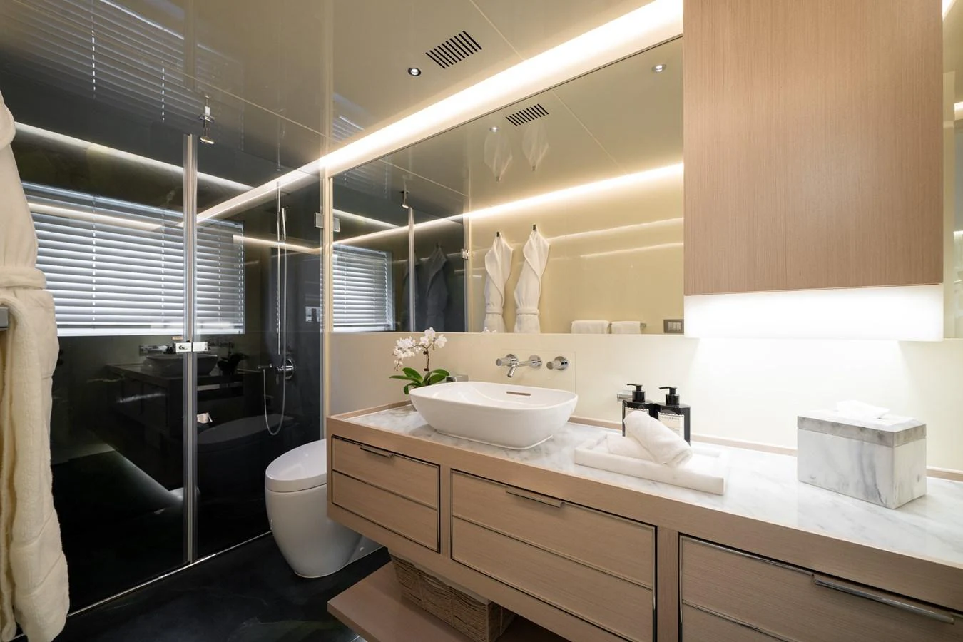 A luxurious yacht bathroom featuring modern fixtures and elegant lighting. aboard M/Y MASHA Yacht for Sale