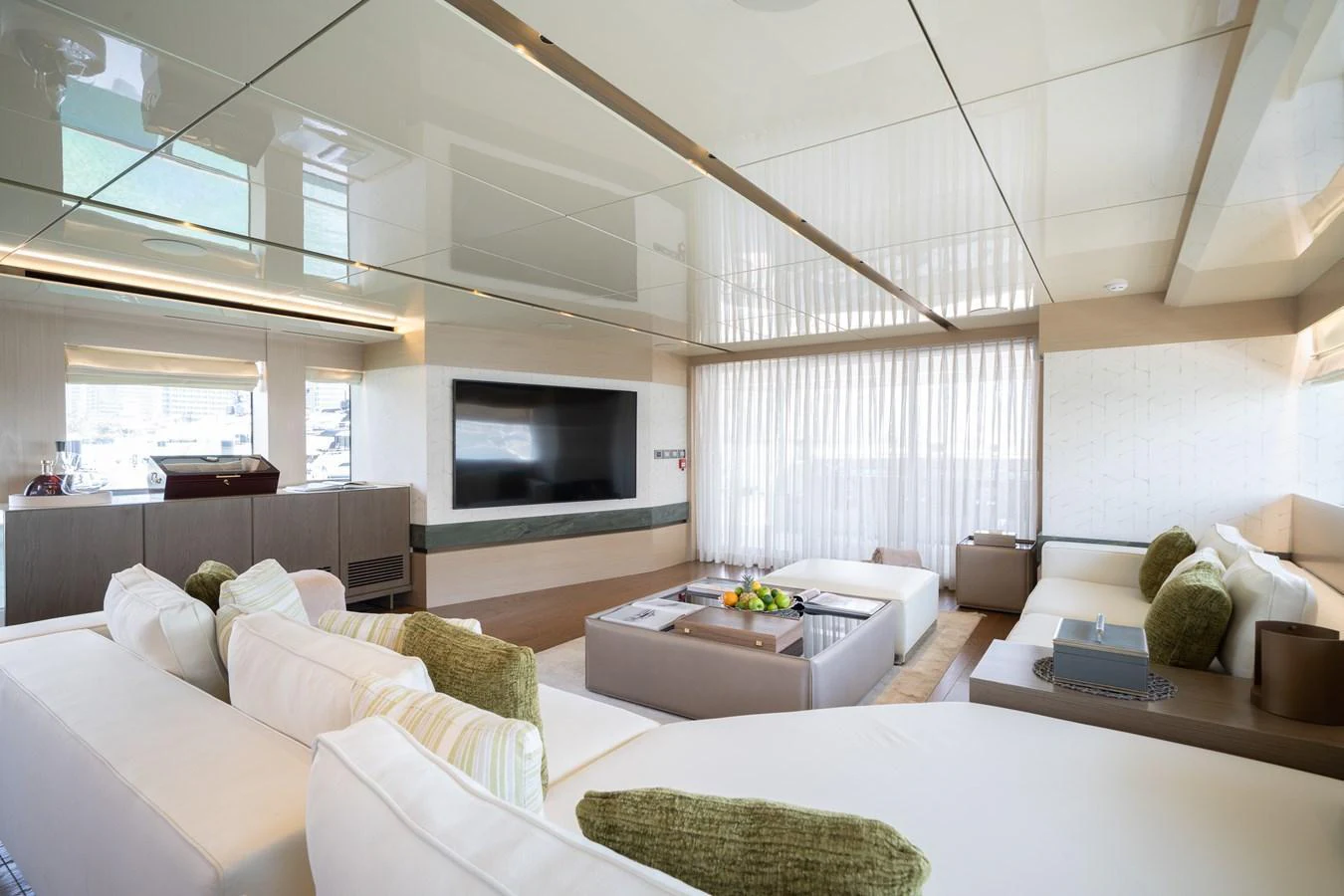 The salon features plush seating, a large flat-screen TV, and ample natural light. aboard M/Y MASHA Yacht for Sale