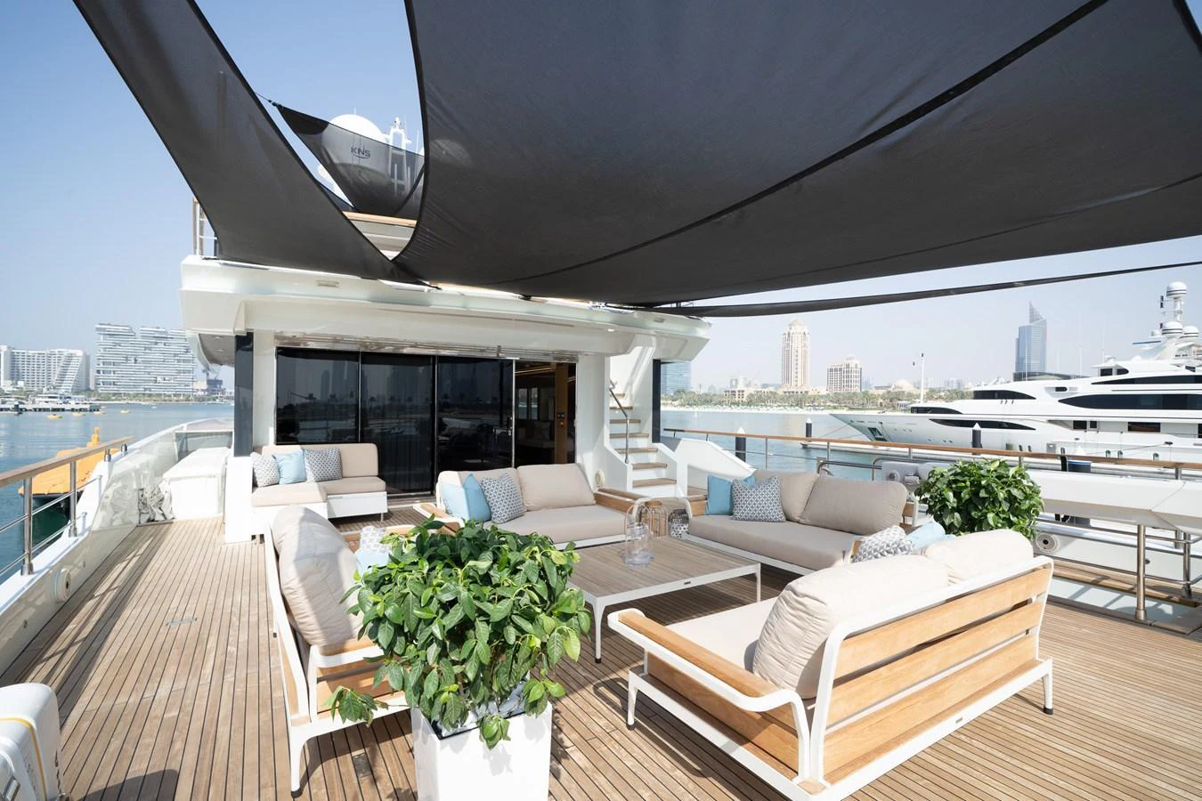 The aft deck features luxurious seating with ample shade and a beautiful view of the marina. aboard M/Y MASHA Yacht for Sale