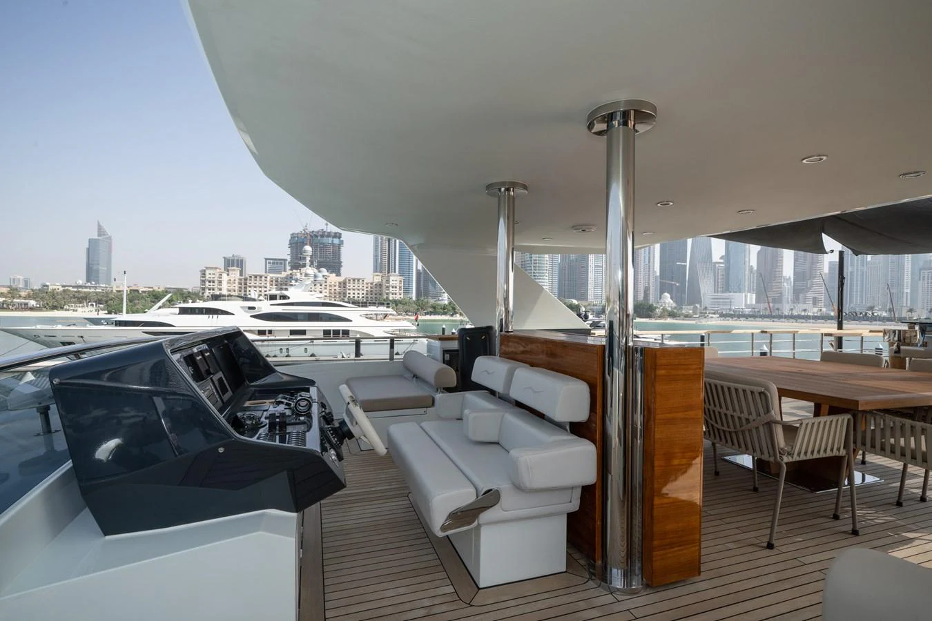The flybridge offers a spacious and luxurious outdoor area with comfortable seating and a dining table, perfect for enjoying panoramic views. aboard M/Y MASHA Yacht for Sale