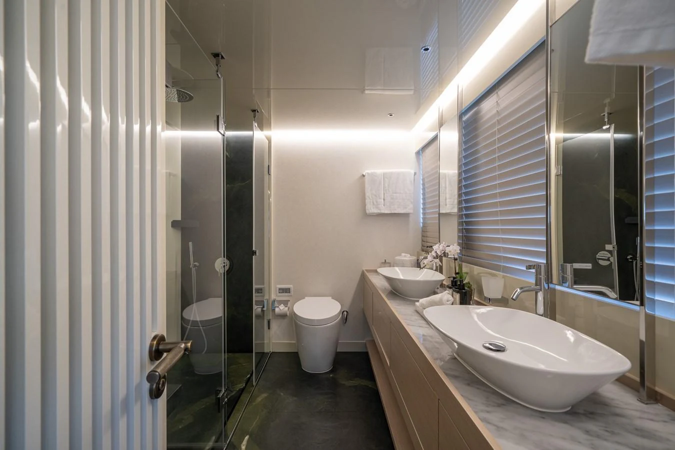 A sleek and modern bathroom with elegant fixtures and ample lighting. aboard M/Y MASHA Yacht for Sale