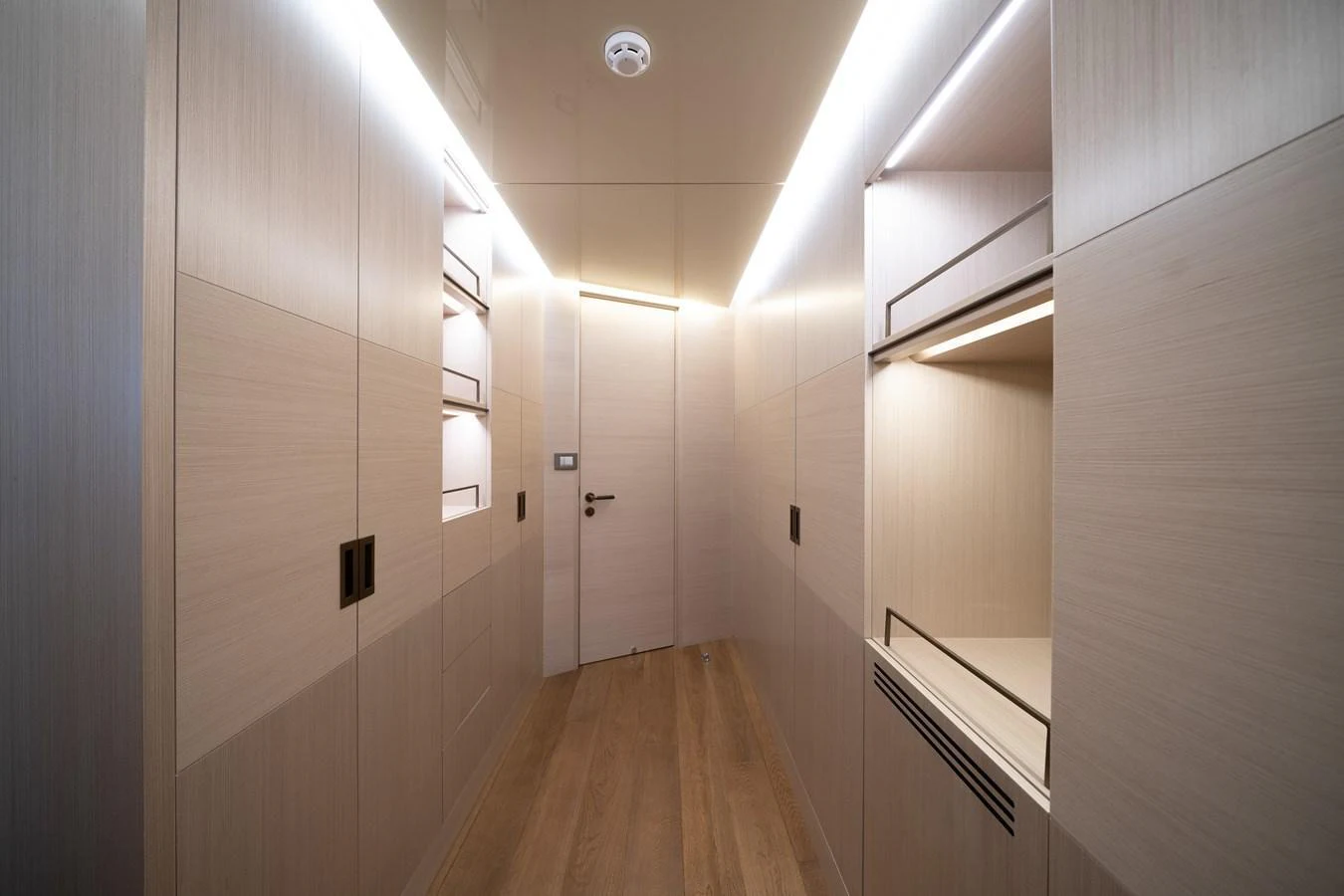 A sleek and modern hallway with wooden paneling and ambient lighting. aboard M/Y MASHA Yacht for Sale