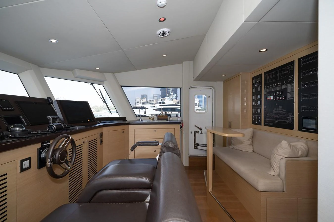 The helm of the yacht features modern navigation equipment and a comfortable seating area. aboard M/Y MASHA Yacht for Sale
