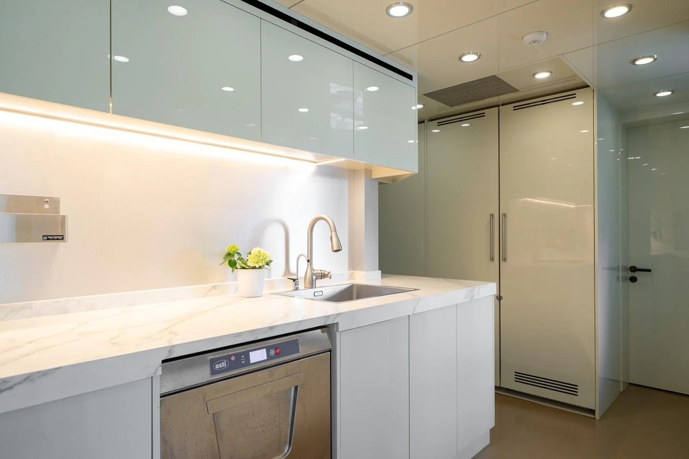 The galley features modern appliances and sleek cabinetry, creating a clean and functional space. aboard M/Y MASHA Yacht for Sale