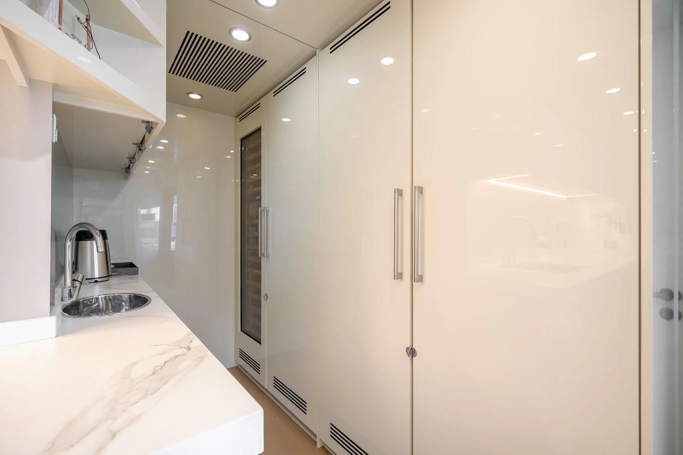 The galley features sleek cabinetry and modern appliances, creating a clean and functional space. aboard M/Y MASHA Yacht for Sale