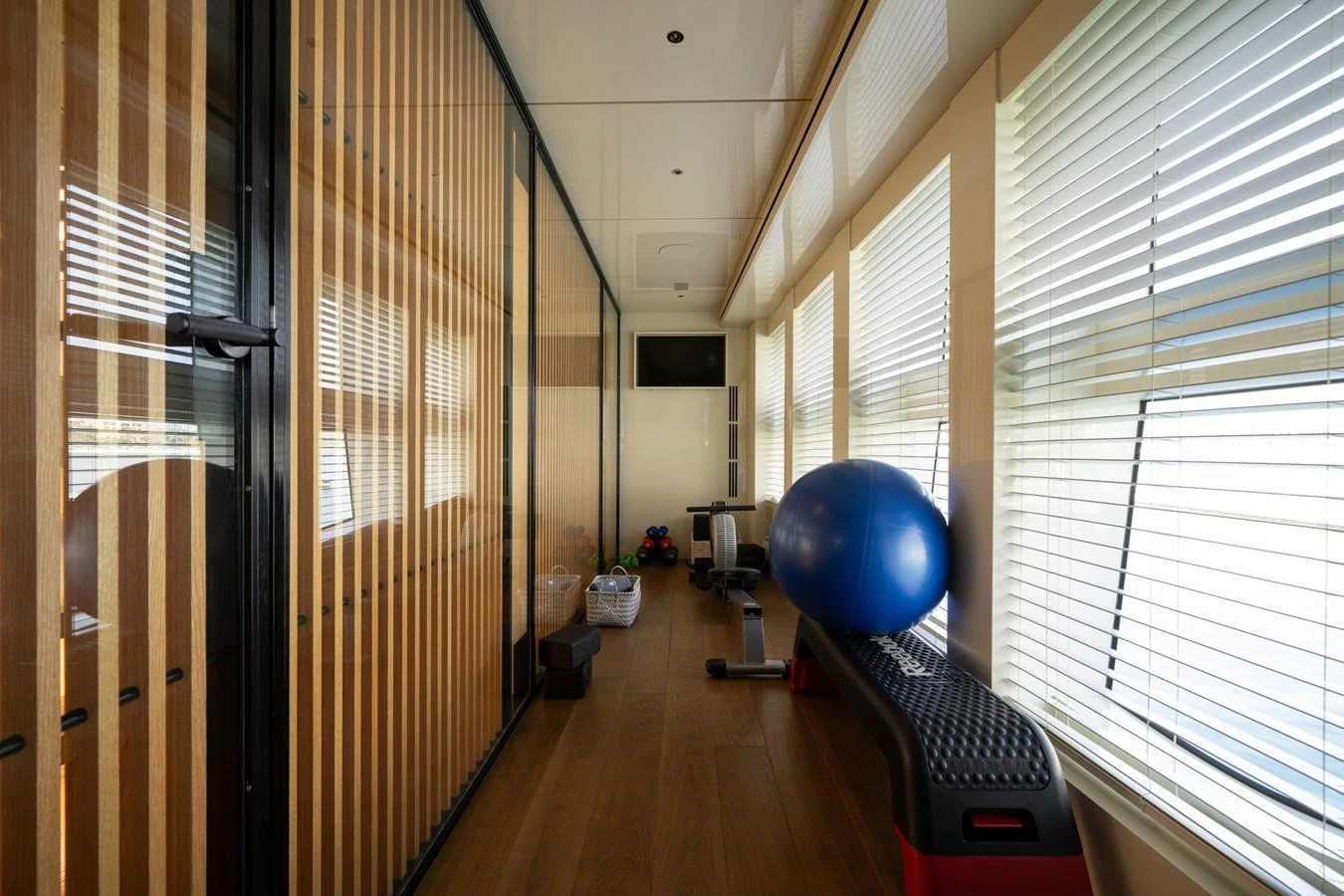 The yacht features a well-equipped gym with ample natural light and modern fitness equipment. aboard M/Y MASHA Yacht for Sale