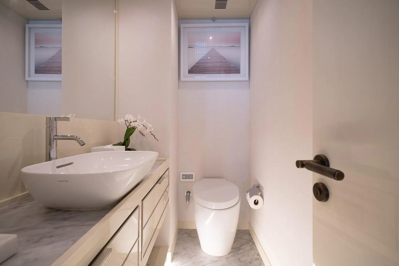The yacht's bathroom features a modern sink and toilet with elegant decor. aboard M/Y MASHA Yacht for Sale