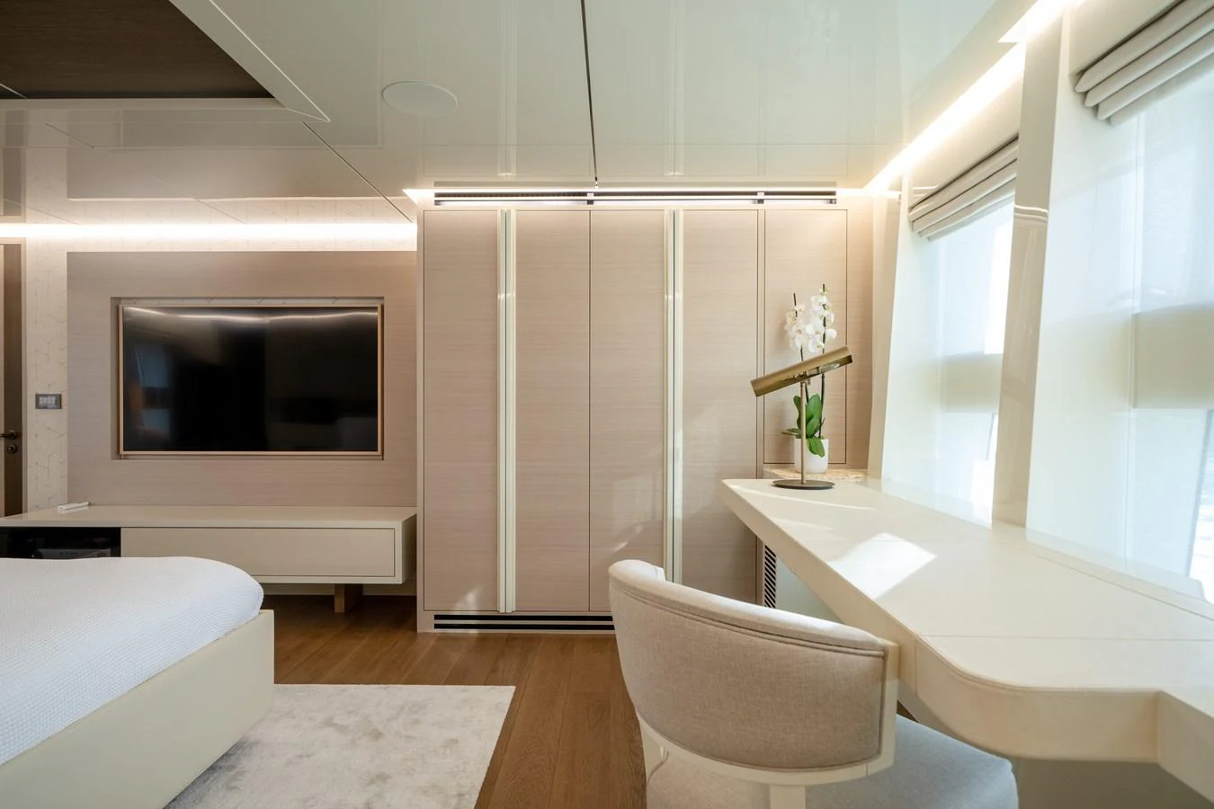 A luxurious stateroom featuring a sleek desk, comfortable chair, and modern decor. aboard M/Y MASHA Yacht for Sale