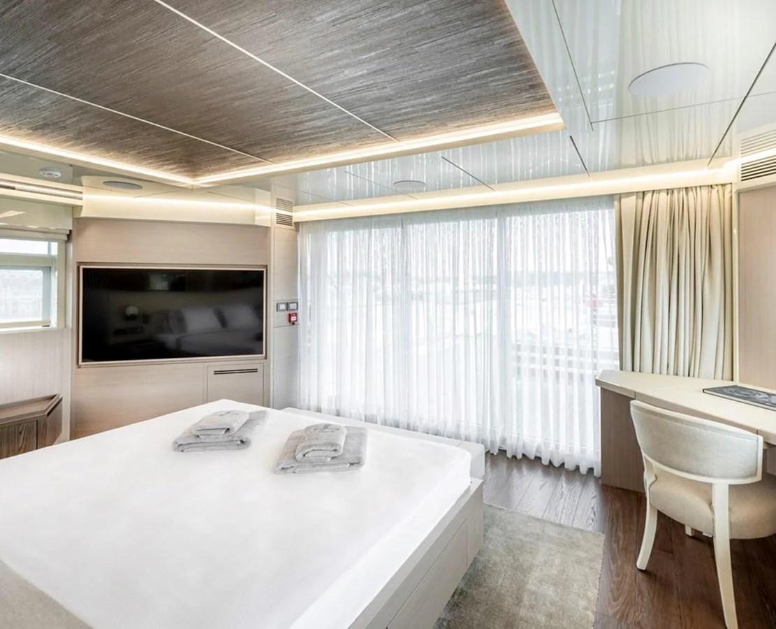 The master stateroom features a spacious bed, large windows, and modern decor. aboard M/Y MASHA Yacht for Sale