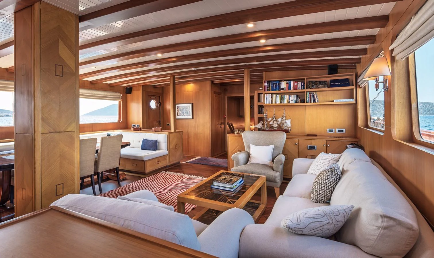 The salon exudes warmth and comfort with its wooden finishes and plush seating. aboard AEGEAN Yacht for Sale