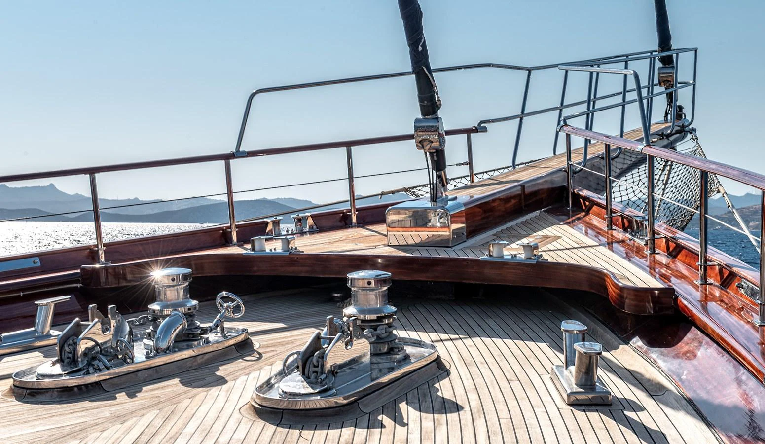 The foredeck of the yacht features polished wood and stainless steel fittings, offering a luxurious and functional space. aboard AEGEAN Yacht for Sale