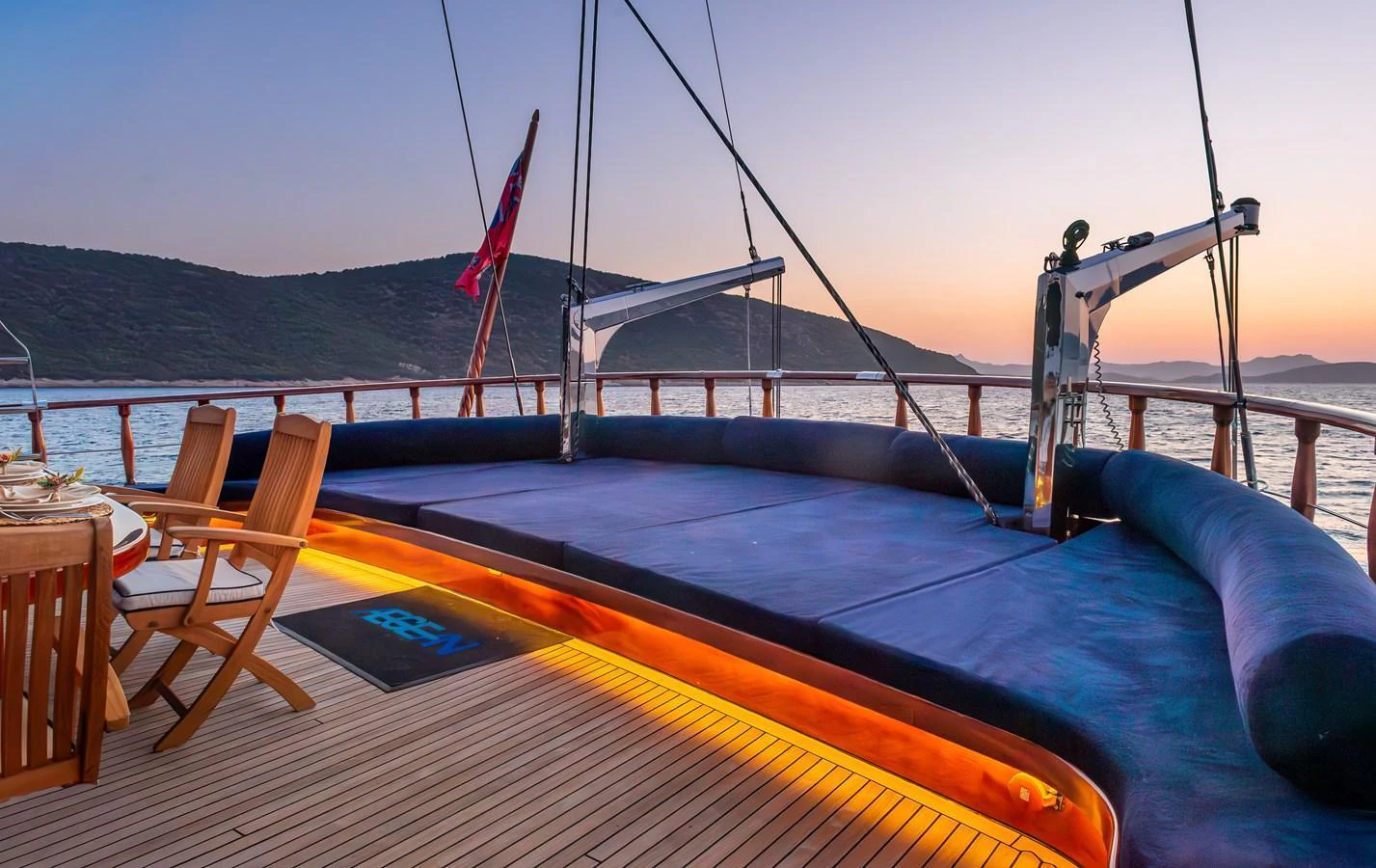 The aft deck features a spacious lounging area with elegant lighting, perfect for sunset relaxation. aboard AEGEAN Yacht for Sale