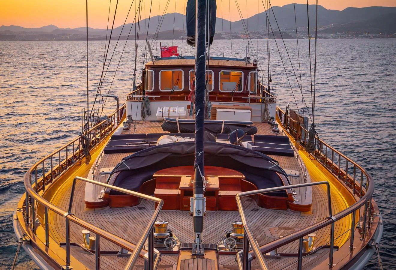 The aft deck of this yacht offers a serene and inviting space with a beautiful sunset backdrop. aboard AEGEAN Yacht for Sale