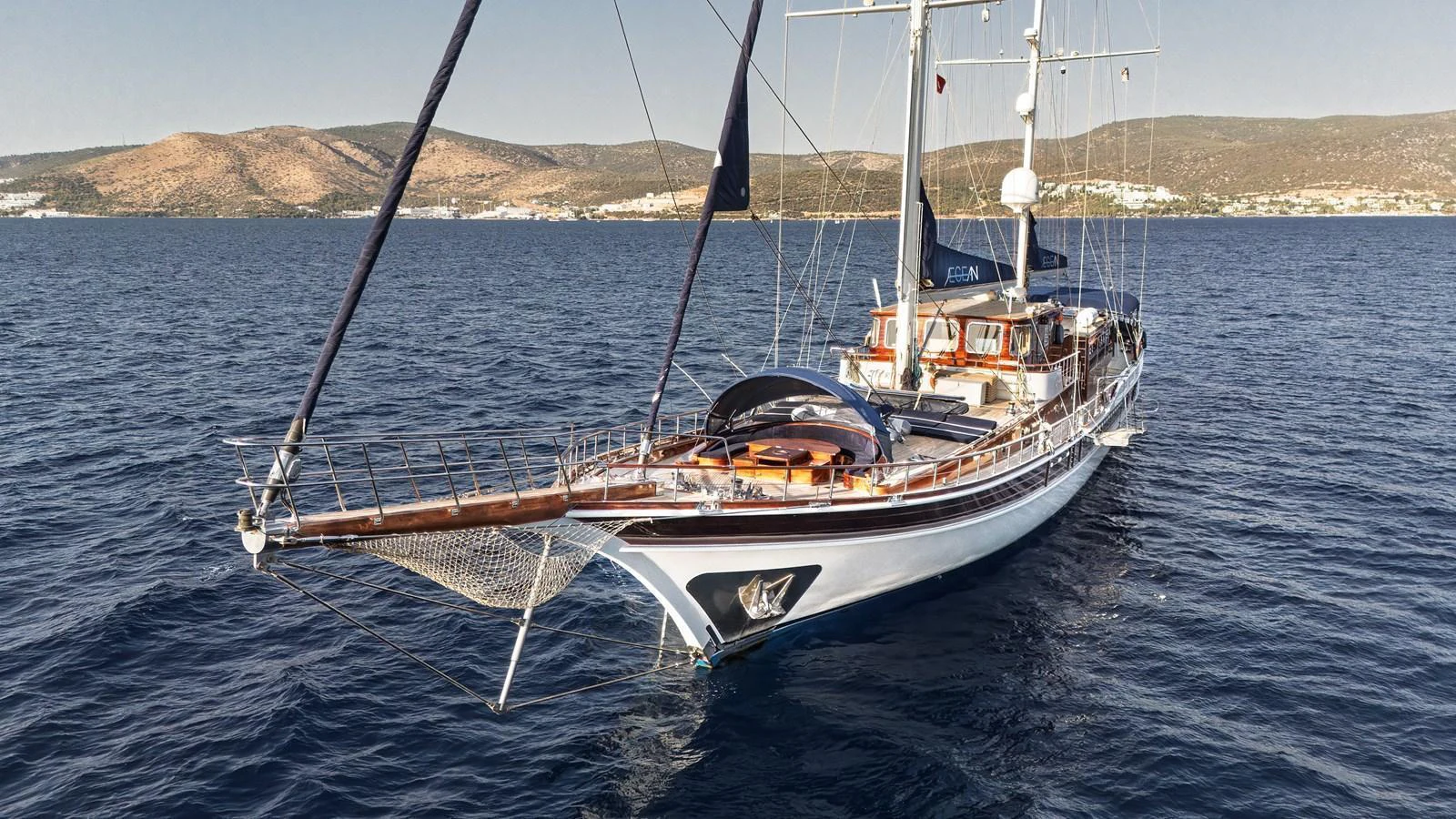 This elegant yacht glides gracefully on the open sea, showcasing its sleek design and luxurious amenities. aboard AEGEAN Yacht for Sale
