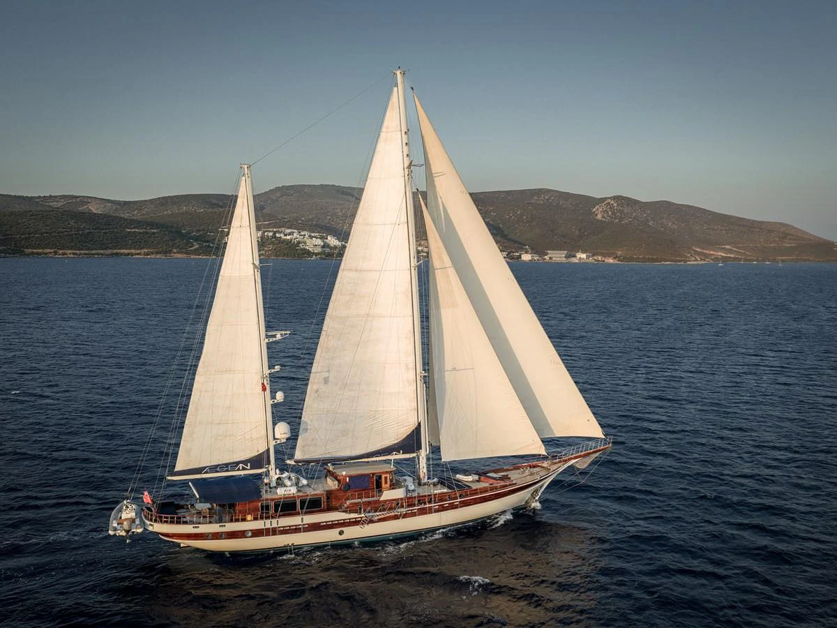 A classic sailing yacht glides gracefully on the open water under full sail. aboard AEGEAN Yacht for Sale