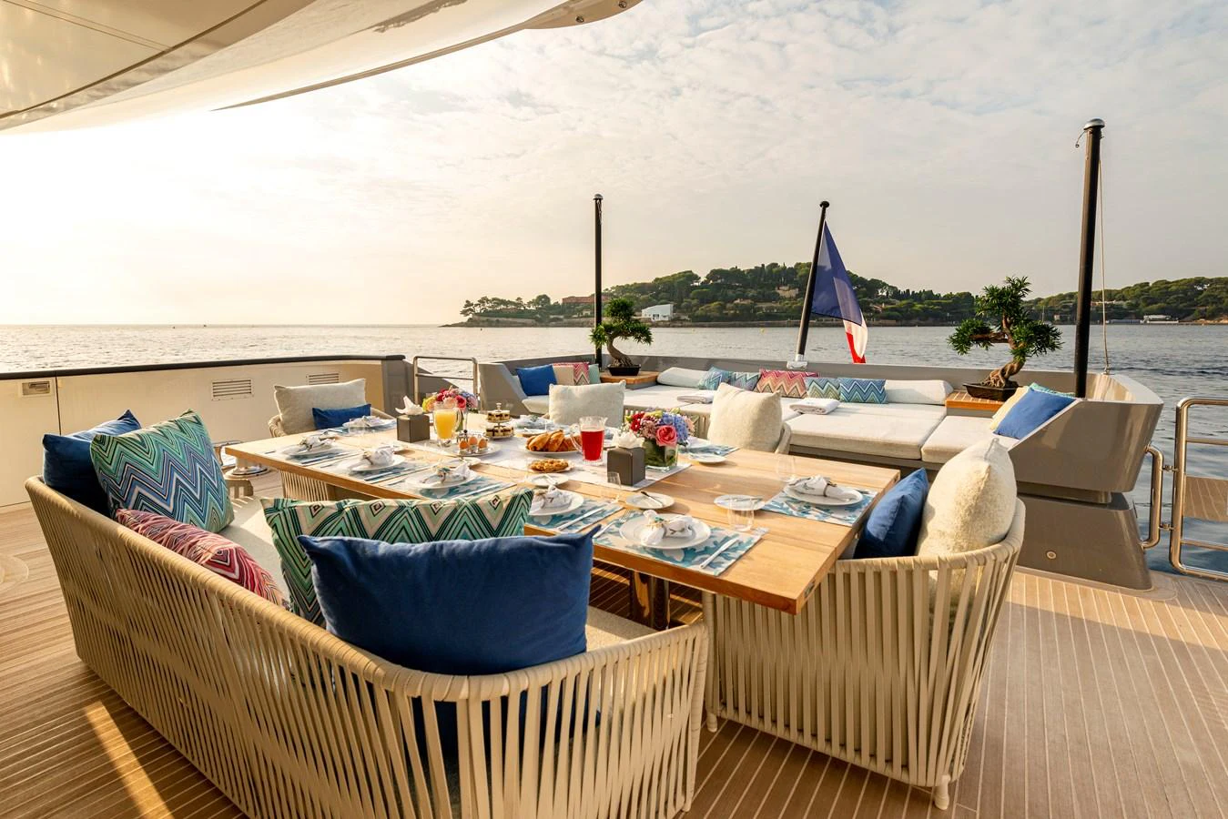 The aft deck features an elegant dining area with a stunning ocean view. aboard GEMS II Yacht for Sale