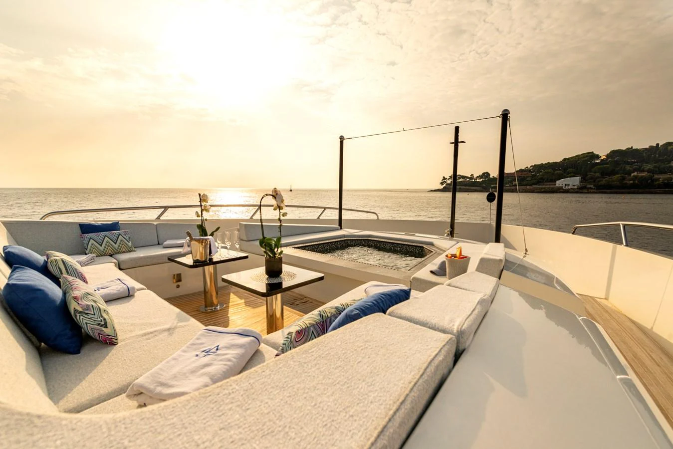 The sundeck offers a luxurious lounging area with plush seating and a jacuzzi, perfect for relaxation while enjoying the sea view. aboard GEMS II Yacht for Sale