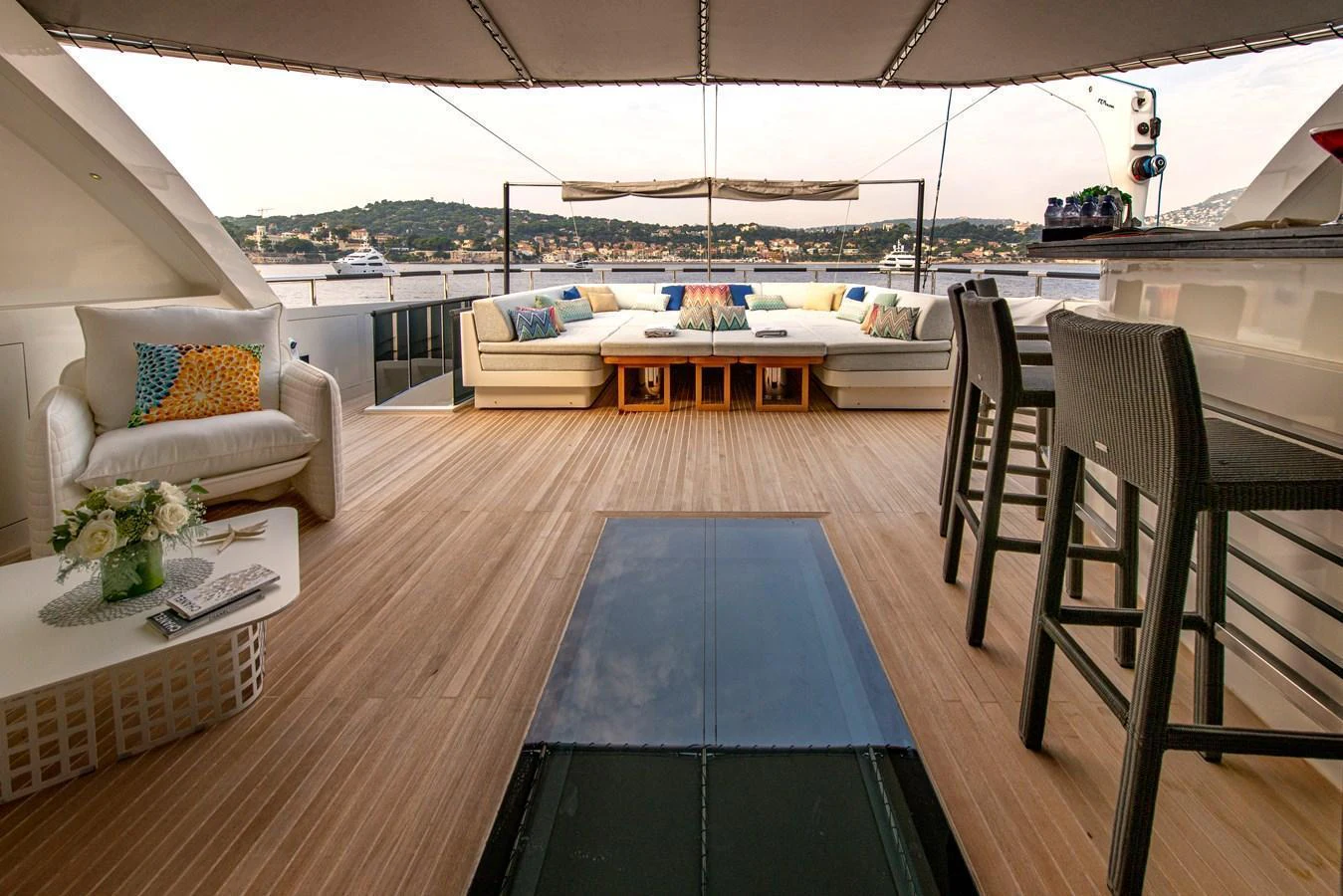 The aft deck offers a spacious and inviting area with comfortable seating and a beautiful view. aboard GEMS II Yacht for Sale
