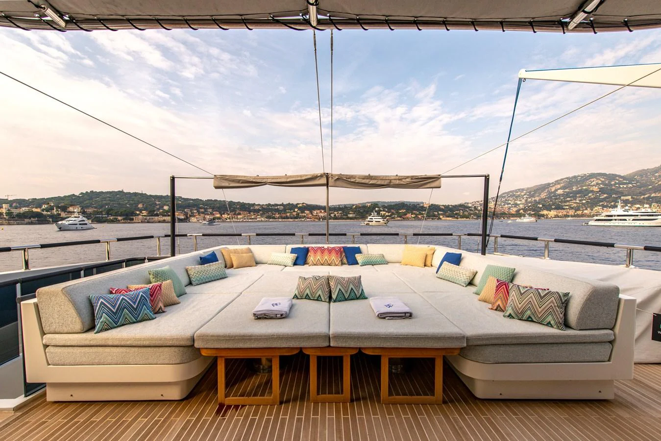 The sundeck features a spacious lounging area with plush cushions and panoramic views. aboard GEMS II Yacht for Sale