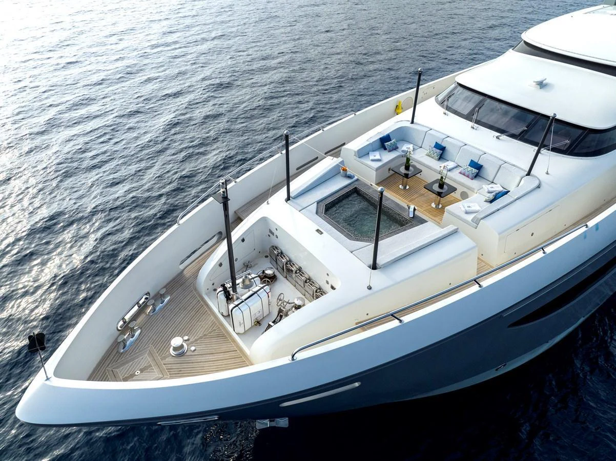 The yacht's foredeck features a luxurious seating area with a central glass-bottomed section, perfect for relaxation and enjoying the view. aboard GEMS II Yacht for Sale