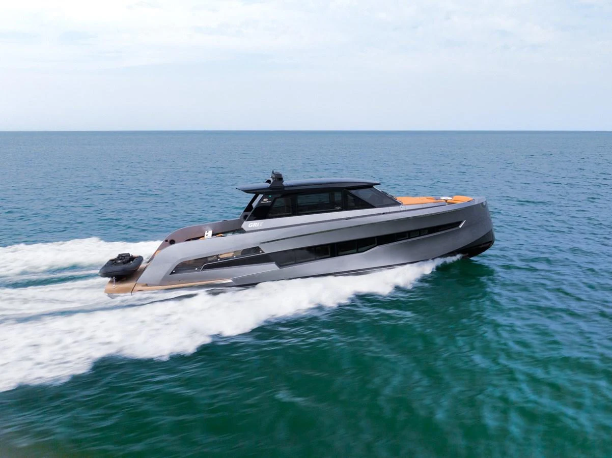 A sleek, modern yacht cruises swiftly on the open sea, showcasing its elegant design and powerful performance. aboard GRIT Yacht for Sale