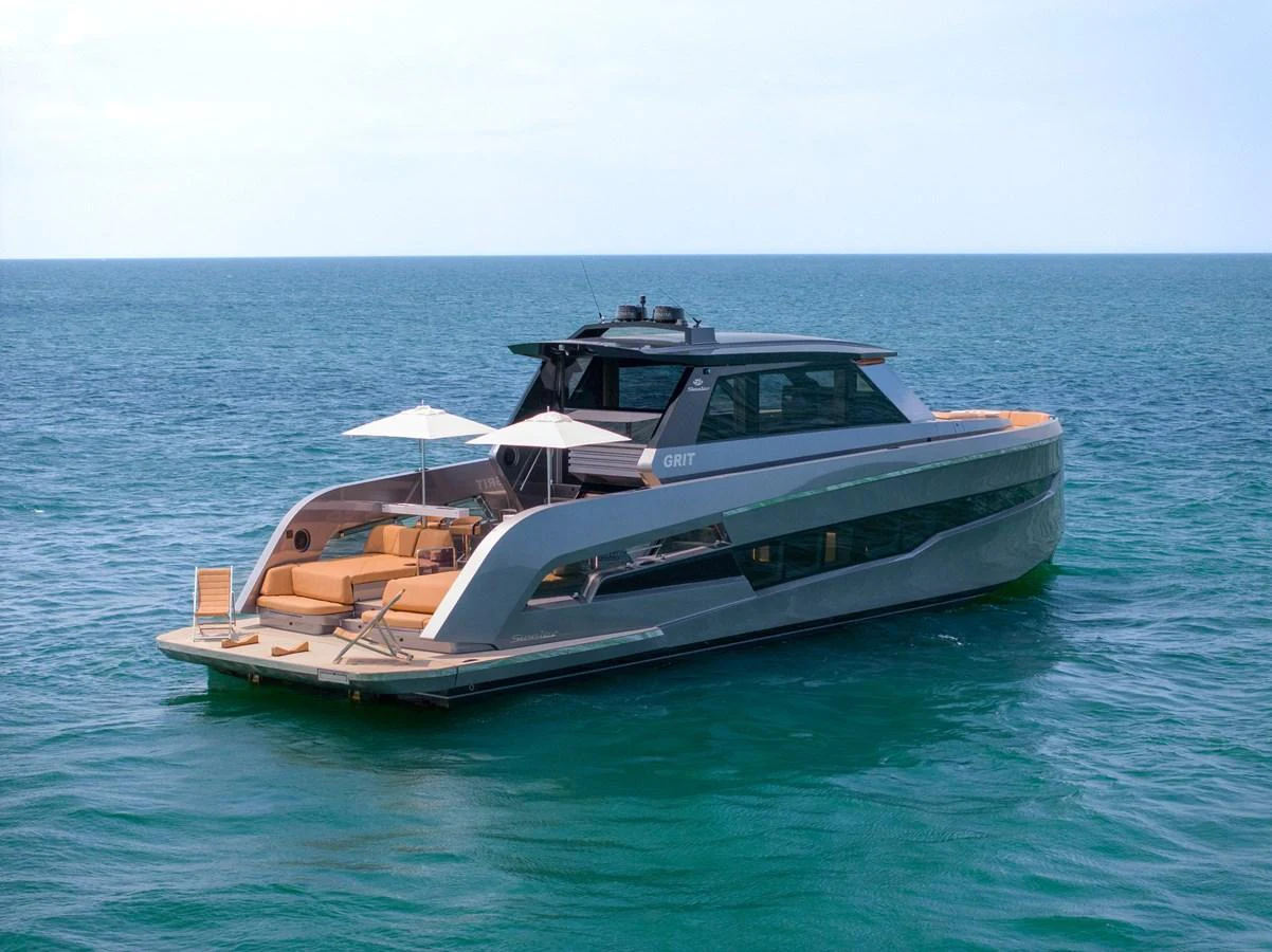 A sleek and modern yacht cruising on calm blue waters, showcasing its luxurious design and spacious deck area. aboard GRIT Yacht for Sale