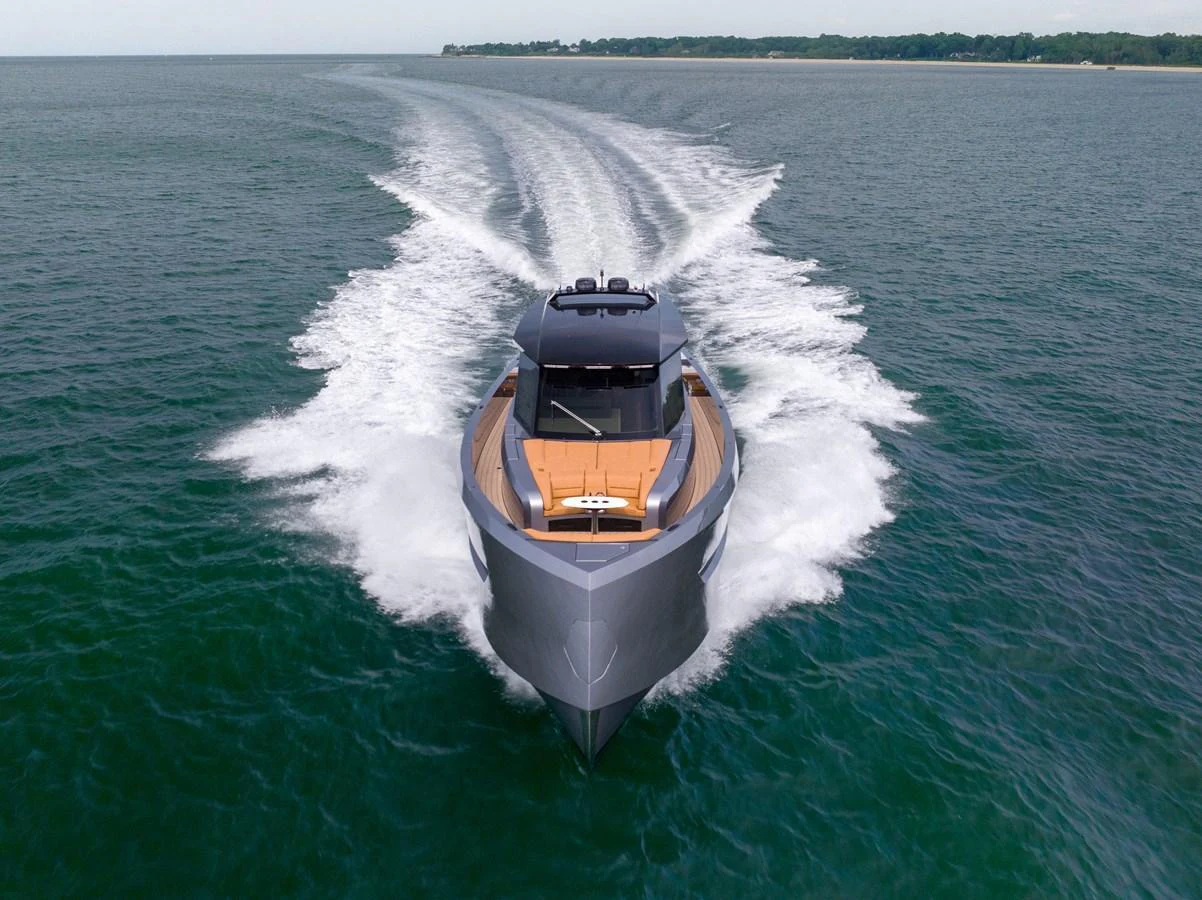 A sleek yacht cruises swiftly through open waters, showcasing its modern design and powerful performance. aboard GRIT Yacht for Sale