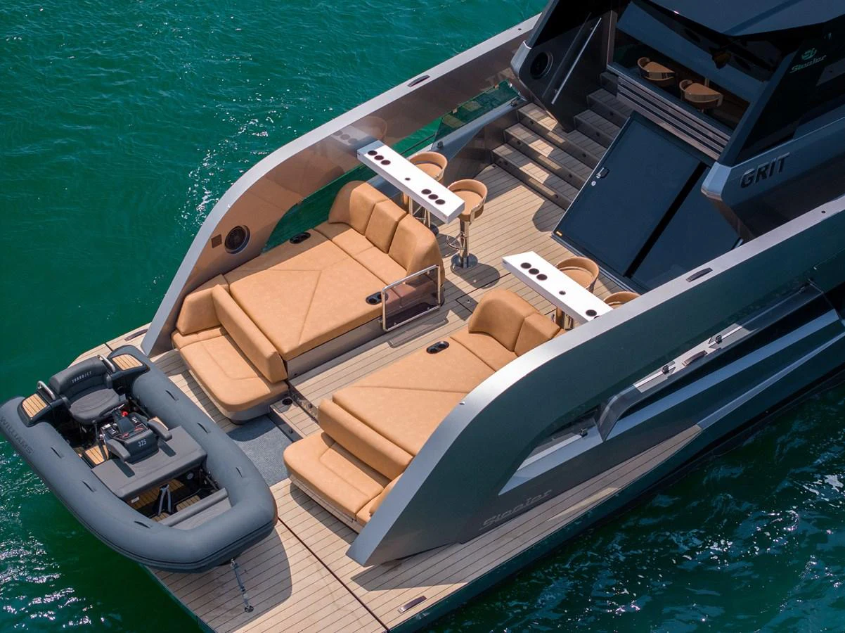The yacht's aft deck features luxurious sun loungers and a tender, perfect for relaxation and water activities. aboard GRIT Yacht for Sale