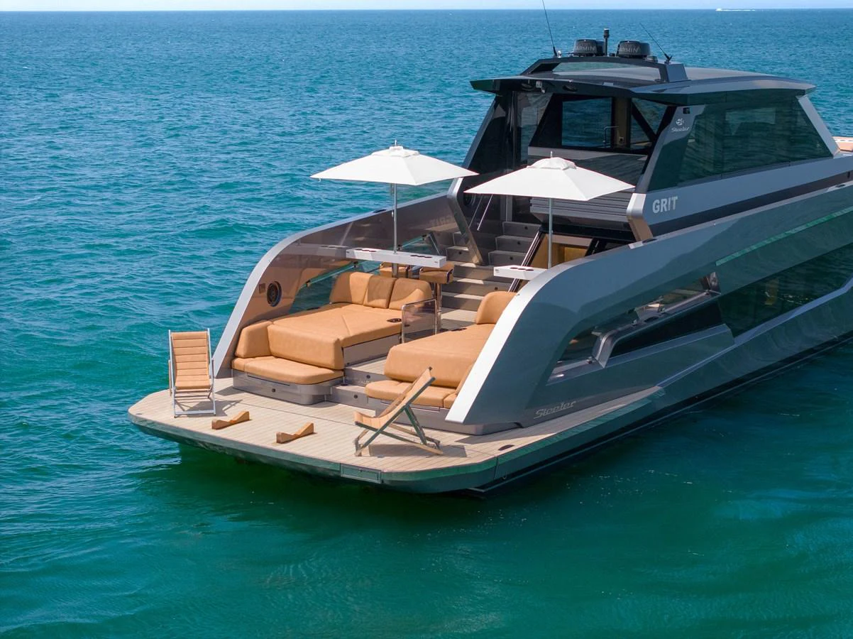 The yacht's aft deck features luxurious sun loungers and umbrellas, perfect for relaxation on the water. aboard GRIT Yacht for Sale