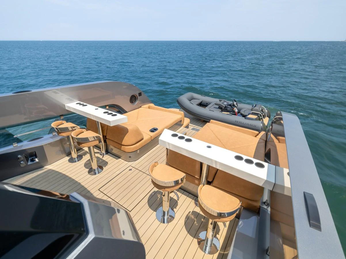 The yacht's aft deck features luxurious seating and a tender, perfect for relaxation and adventure. aboard GRIT Yacht for Sale