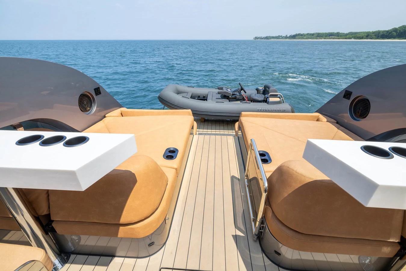 The aft deck features comfortable seating and a view of the tender on the water. aboard GRIT Yacht for Sale