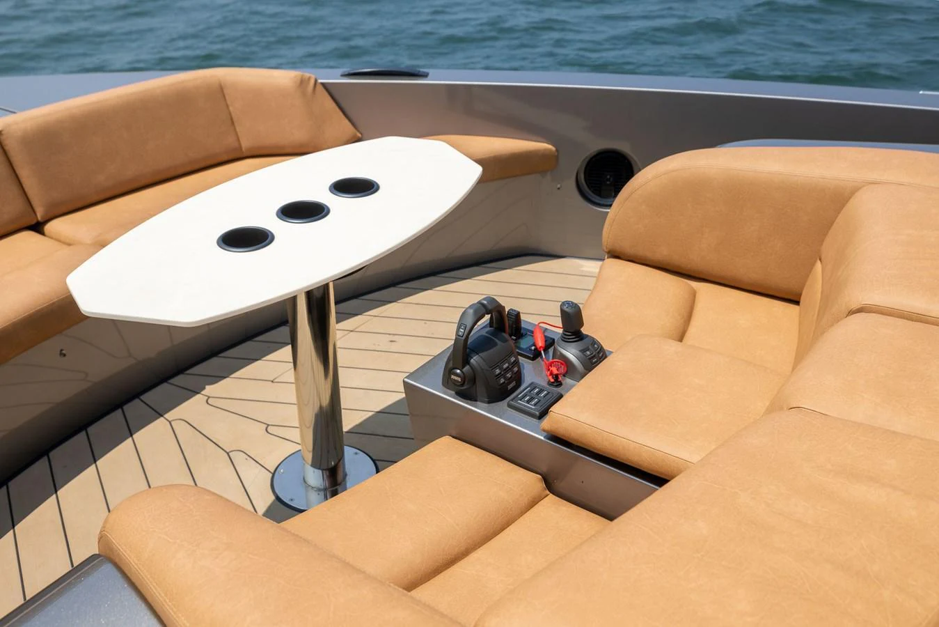 The image showcases a luxurious seating area with a control panel on the yacht's deck. aboard GRIT Yacht for Sale