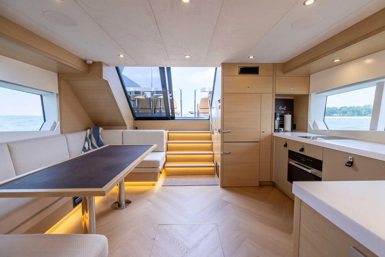 The salon features a modern design with ample natural light and comfortable seating. aboard GRIT Yacht for Sale