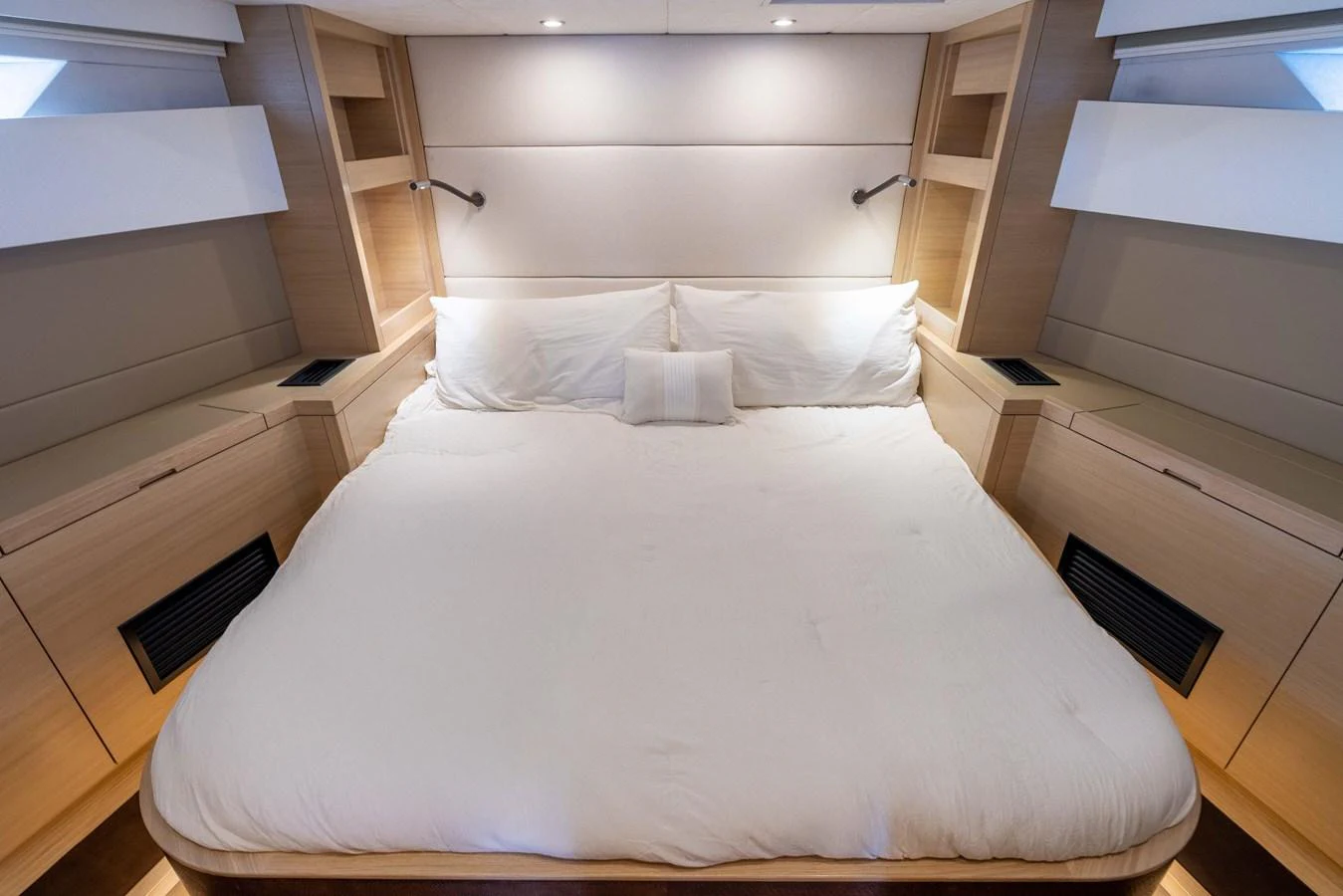 The stateroom features a spacious and inviting bed with modern, elegant decor. aboard GRIT Yacht for Sale