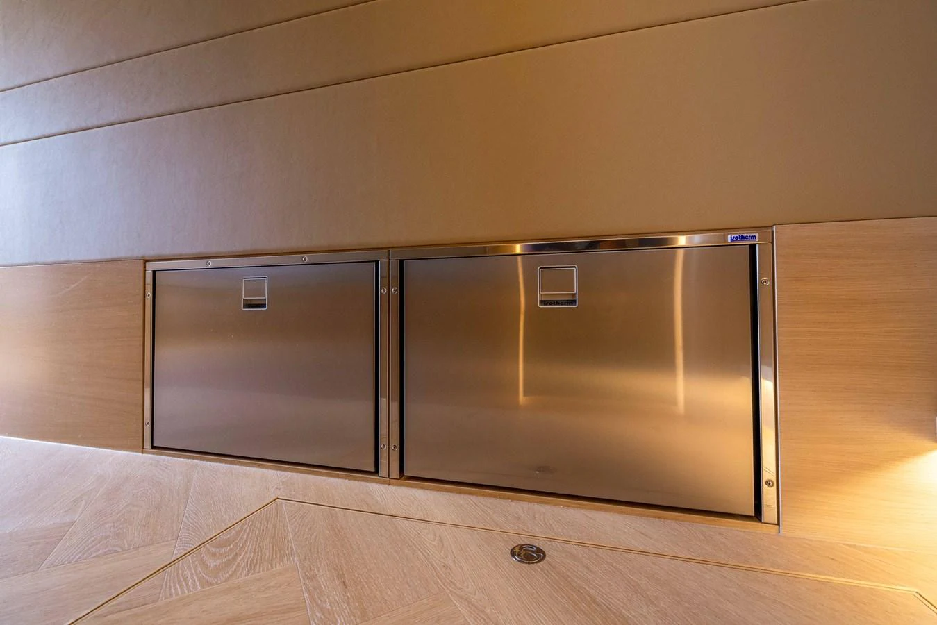 The image showcases sleek, stainless steel storage compartments integrated into the yacht's interior wall. aboard GRIT Yacht for Sale