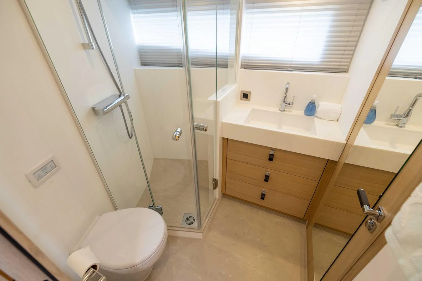 The yacht's bathroom features a modern design with a glass-enclosed shower and sleek fixtures. aboard GRIT Yacht for Sale