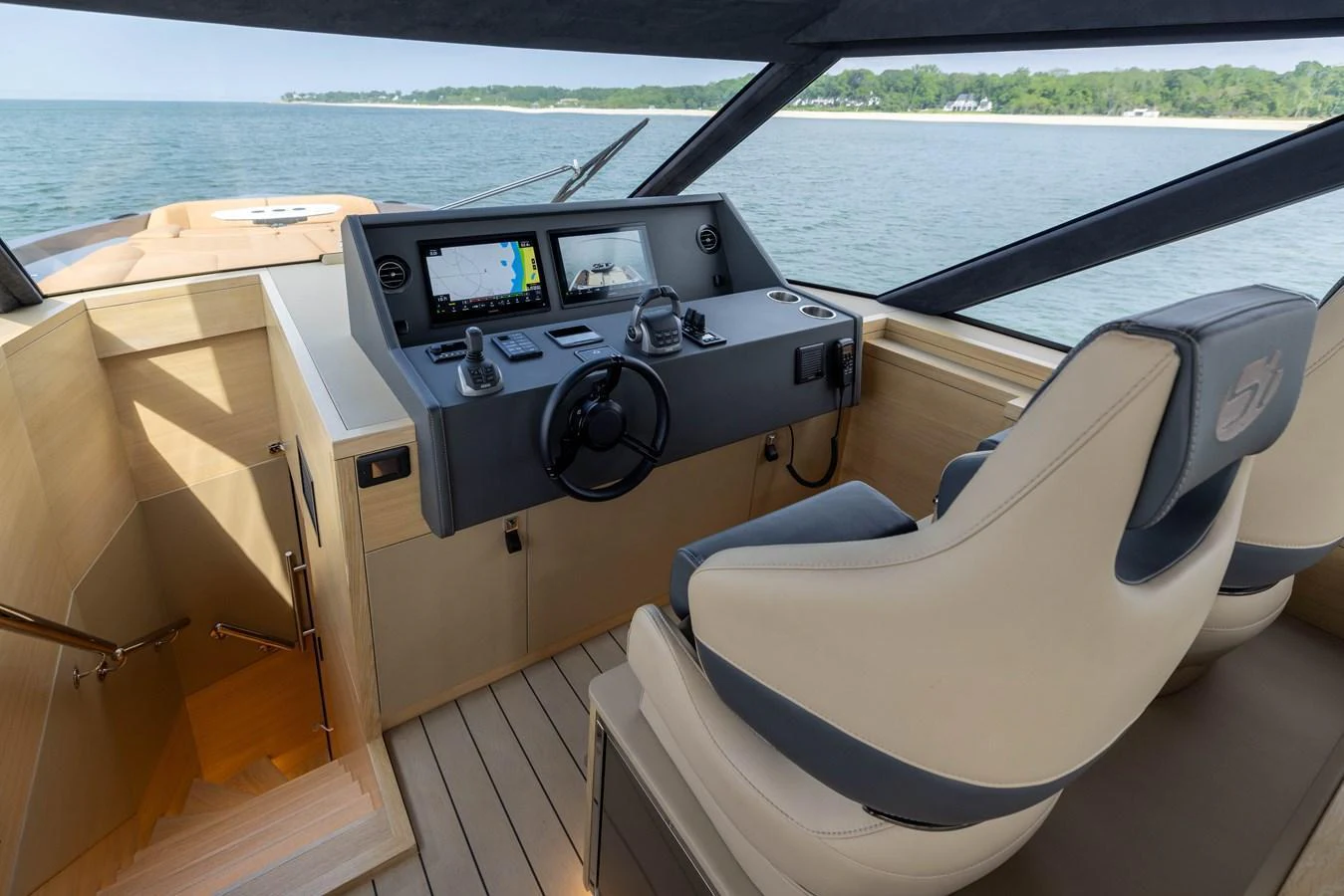 The helm station offers a commanding view with modern navigation equipment and comfortable seating. aboard GRIT Yacht for Sale