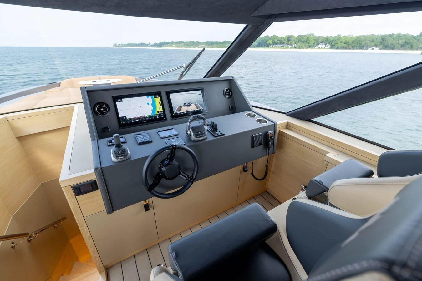 The helm features modern navigation equipment and comfortable seating with a scenic view of the water. aboard GRIT Yacht for Sale