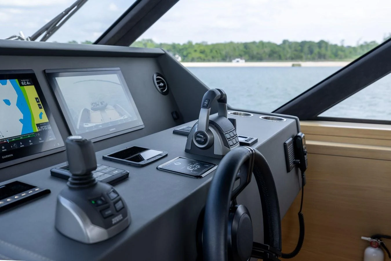 The helm station features advanced navigation equipment and a sleek design, offering a commanding view of the surroundings. aboard GRIT Yacht for Sale