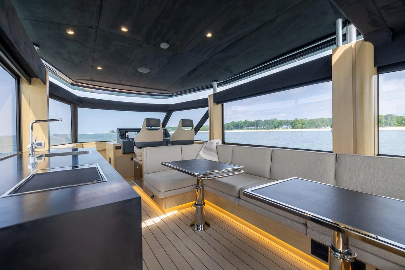 The saloon offers a spacious and modern setting with panoramic views and luxurious seating. aboard GRIT Yacht for Sale