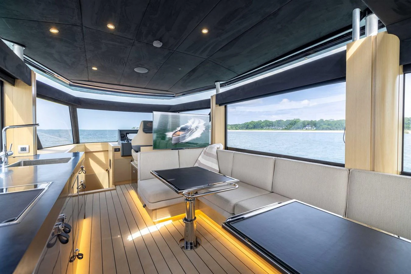 The yacht's saloon features modern furnishings with ample natural light and scenic views. aboard GRIT Yacht for Sale